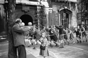 Children Only Prints: Children playing Oranges and Lemons in the Church of St Clement Danes London. Circa 1946
