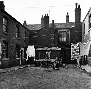 Children playing outside slum housing Number Two Court, Dickenson Street, Oldham