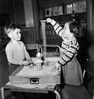 00011 Prints: Children playing in the sand pit in class at Cookham Nursery School
