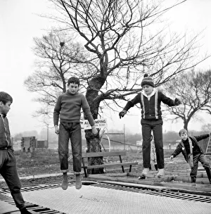 00033 Prints: Children playing on trampolines in the adventure playground at Basildon, Town centre