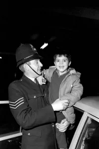 Children with policemen: A six year old boy who calls himself George Mason is