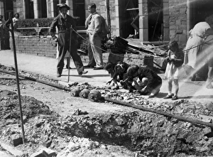 Danger Prints: Children search for bomb shrapnel in the gutters of Edward Street, Redfield