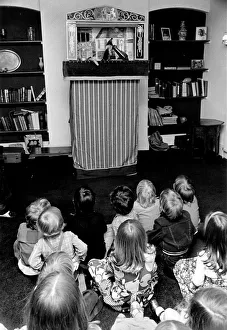 Puppets Prints: Children sitting on the floor watching the Pinch and Judy puppet show at a party