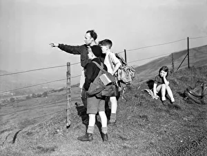 Sussex Prints: Children staying at the local youth hostel seen here hiking over the South Downs
