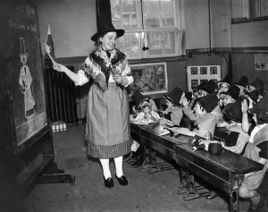 Children and teacher all in Welsh costume in classroom of Cardiff School