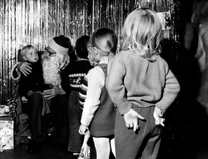 Santa Prints: Children waiting in line to see Father Christmas at a store in Ilford, Essex