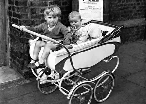 Dummy Prints: Children waiting in their pram outide the polling boothwhilst their mothers vote in
