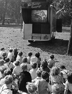00095 Prints: Children watch an open air cinema performance of Ralph Readers Gang Show