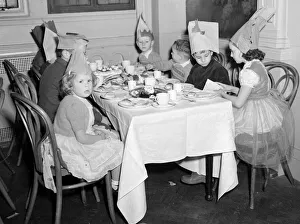 00192 Prints: Children at the yearly Daily Mirror Christmas Childrens Party tuck into their tea