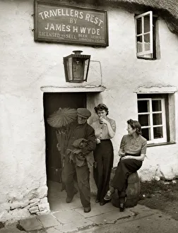 00135 Prints: A chimney sweep passes two land girls enjoying a well earnt break from their toil in