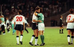 Chris Waddle Football is consoled and embraced by Lothar Matthaus of W Germany after