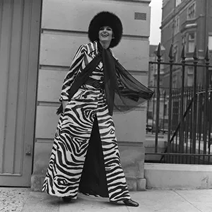 Animal Print Prints: Christine Maxey wearing a zebra print trouser-suit and tunic top with black hat