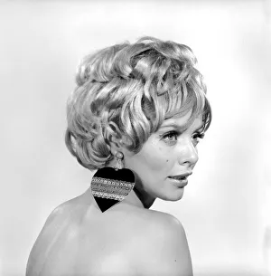 Christmas Earrings: Uschi Bernell modelling Christmas design earrings. 1965 D178-009