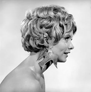 00061 Prints: Christmas Earrings: Uschi Bernell modelling Christmas design earrings. 1965 D178-005