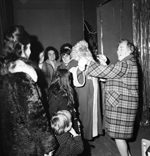 Store Prints: Christmas Humour - Santa. Father Christmas enjoys a dance at Lewis
