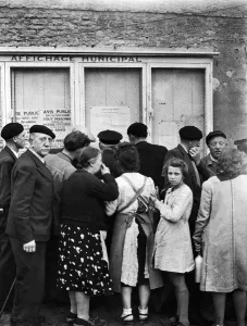 Allies Prints: Citizens of Courseulles, Normandy read public notices put up by the Allied military