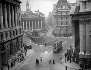 City workers carry on with their daily routines walking past the damage caused by German