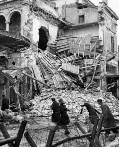 01453 Prints: Civilians in Athens moving through destroyed buildings during curfew hours. January 1945