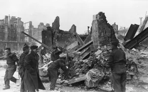 Clearing away rubble at a scene of destruction in London following an air raid during