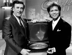 Cliff Richard Singer actor with Terry Wogan receiving award. November 1988