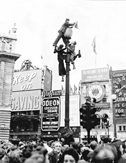 Lamppost Prints: Climbing a lamppost in Piccadilly Circus London to get a better view of the VE-Day