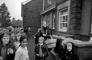 00033 Prints: Clitheroe School Strike. Teacher Miss Kianne Kay surrounded by pupils as she returns to