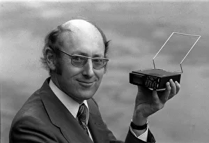 00182 Prints: Clive Sinclair holding the first pocket sized television