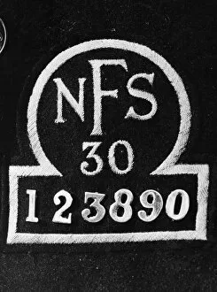 Firemen Collection: Close up of the breast badge of a National Fire Service uniform. September 1941