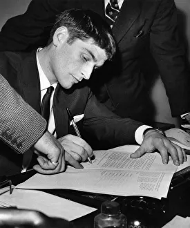 Close up as Johnnie Crossan signs today at Maine Rd, for M / cr