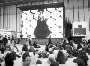 00492 Prints: Clothes Show Live, visitors to the clothes show relax beneath one of the giant video