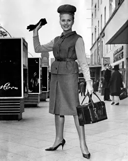 Clothing 1963. Woman wearing a tweed jacket and skirt with handbag and gloves