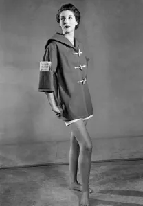 Clothing Beach. Woman wears duffel coat with handy pocket in the sleeve