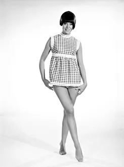 Clothing: Fashion: Dress: Woman wearing gingham dress. 1966 B2008-007