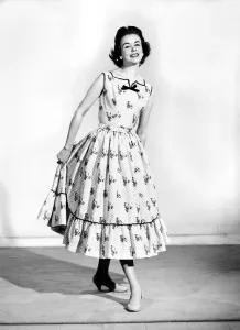 00063 Prints: Clothing: Fashion: Dresses. Woman wearing full length dress with matching gloves
