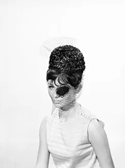 00062 Prints: Clothing: Fashion: Hats: Woman wearing hats with veils and eyepatch. 1962 B1544-031