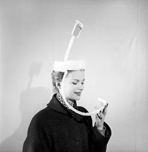 Clothing: Fashion: Hats. Woman wearing periscope hat. 1953 B140-002