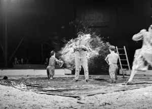 Circus Prints: Clowns, clowning about in the the ring during a performance of the Bertram Mills Circus