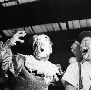 Clowns Michael and Sasha Coco covered in cream after being hit in the face by a pie