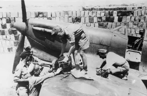 Planes Prints: Co-operating Naval and RAF ground crews re-arm a Spitfire plane on an aerodrome in Malta