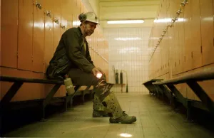 Tired Prints: A coal miner at Ellington Colliery in Northumberland sitting in the locker room after his
