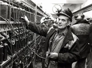 Coal - Miners - Coal miner checks his lamp in at the lamp room at a South Wales Colliery