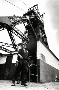 Coal - Miners - General mining shot showing a miner with the winding gear in