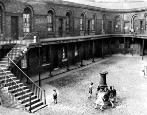 Carefree Prints: In the cobbled courtyard children play round the old lamp standard in Victoria Market