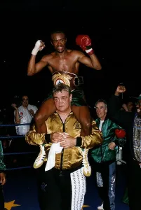 00130 Prints: Colin McMillan Boxing sits on the shoulders of one of his seconds after winning the WBO