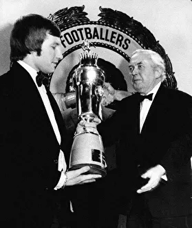 Colin Todd receives the PFA Player of the Year trophy from the Prime Minister Harold