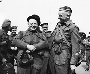 Bowler Hat Prints: Colour Sergeant J. E. Pardoe (left) tries on a bowler hat in Gibraltar whilst waiting to