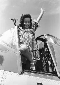 Sandals Prints: Come Fly With Me. Little Lucy Deplidge seen here waving from the cockpit of a Fleet Air