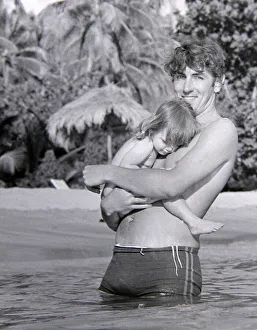 Comedian, actor and publisher Peter Cook with his daughter Lucy during a holiday in