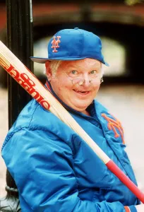 Comedian Benny Hill with baseball bat cap and jacket November 1989