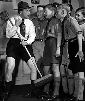 Comedian Charlie Chester wearing a Scouts uniform with as he talks with Boys Scouts